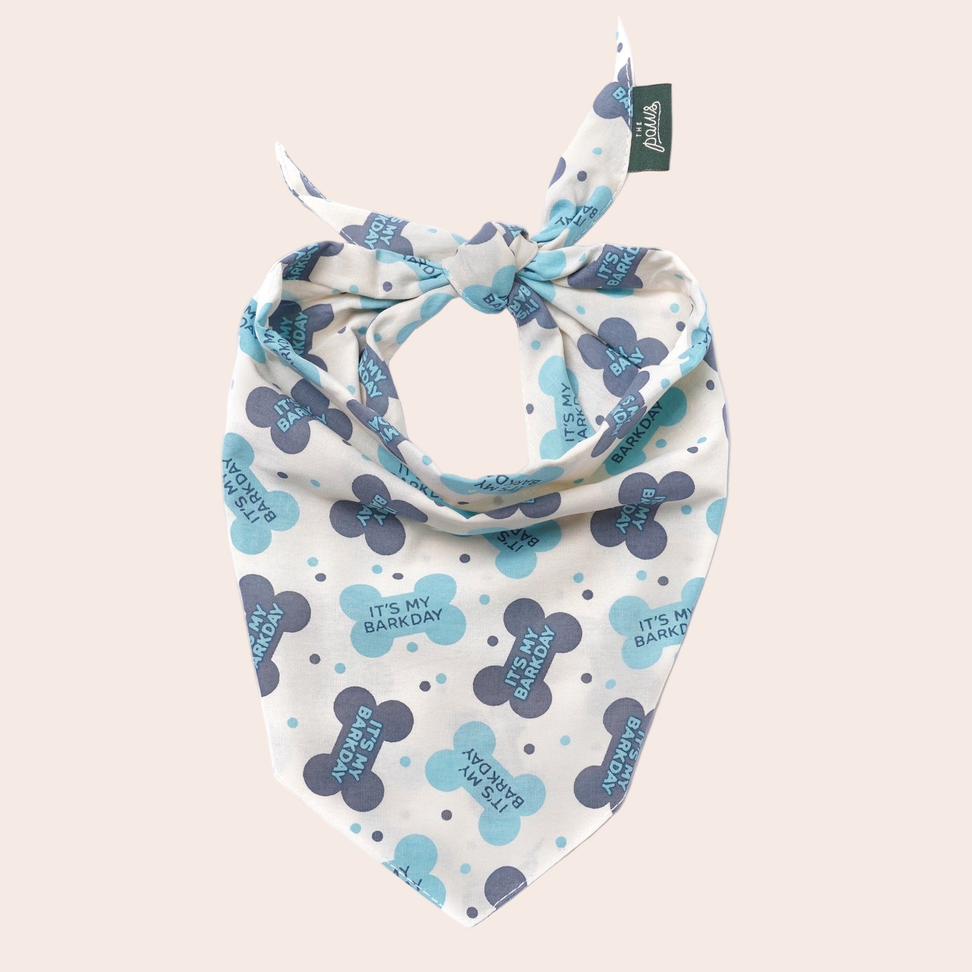 Dog bandana with paw print pattern on a white background