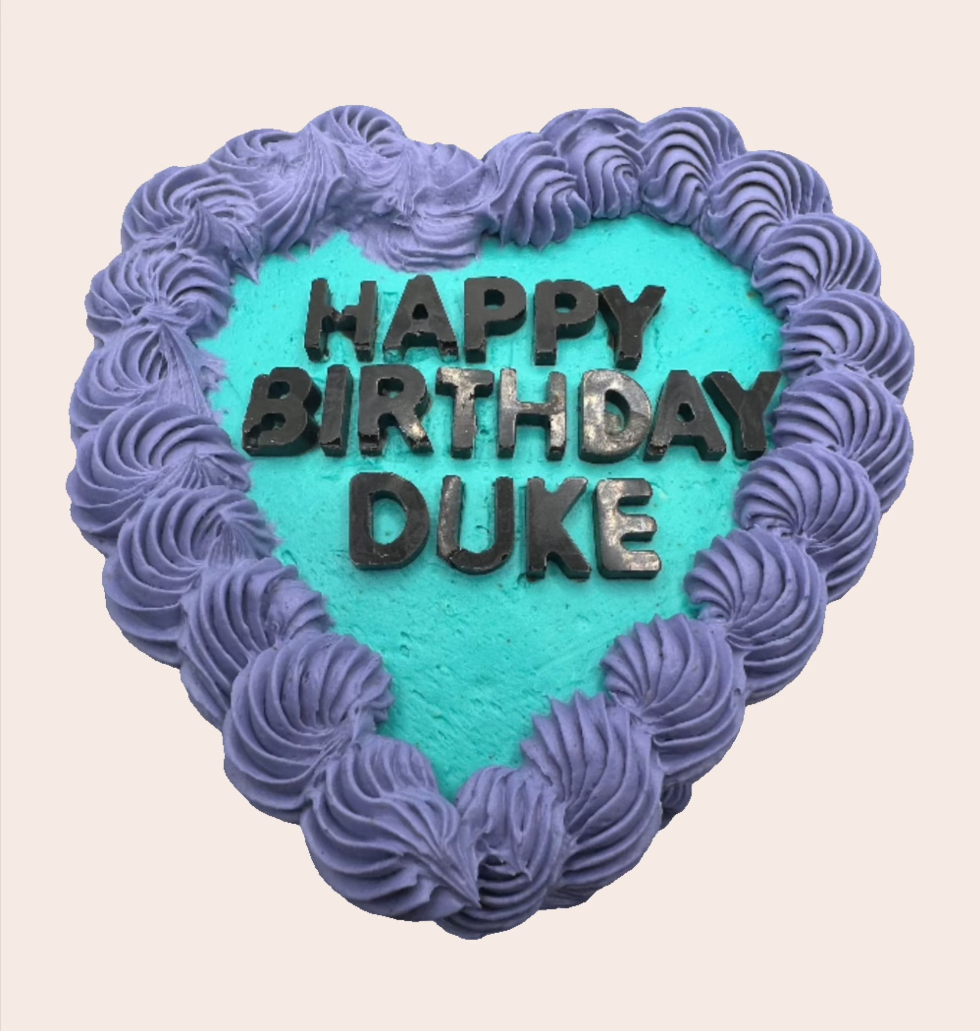 heart shaped cake, vintage icing swirls in contrasting colours.  carob lettering.