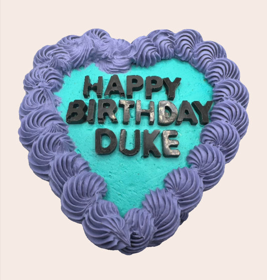 heart shaped cake, vintage icing swirls in contrasting colours.  carob lettering.